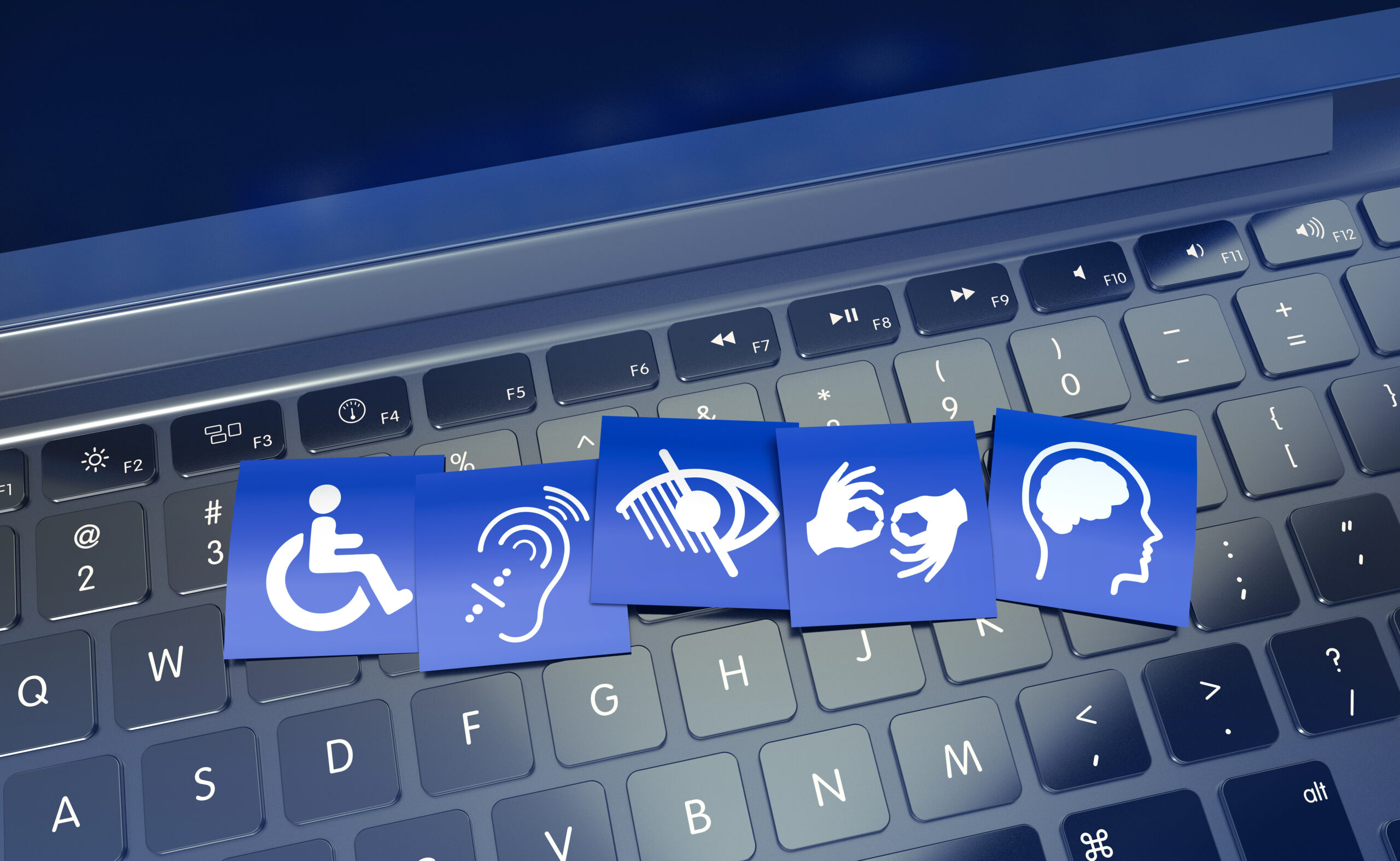 Icônes représentant différents types de handicaps disposées sur un clavier d’ordinateur, symbolisant l’accessibilité numérique.